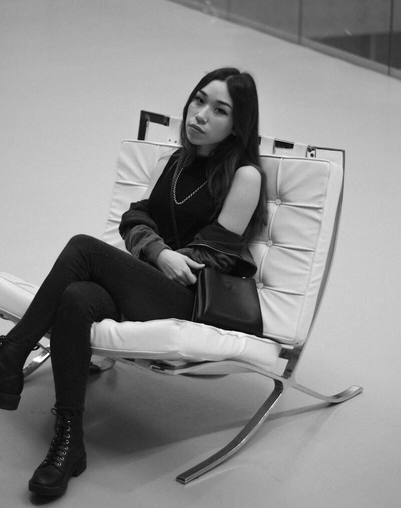 a woman sitting in a chair with her legs crossed